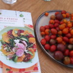 My French Family Table cookbook and a plate of cherry tomatoes for tomato tatin
