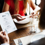 Professional menu translation services | English to Spanish | A couple reading the menu at the restaurant