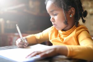 Young girl doing homework | Education and training translation services