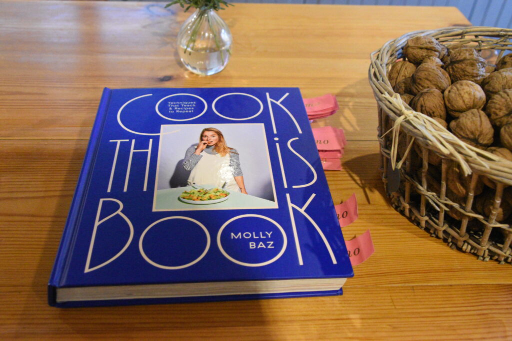 A copy of Cook This Book lays on the kitchen table | Translated into Spanish by Pili Rodríguez Deus and published in 2023