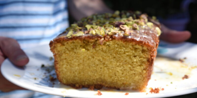 Image: husband holds a homemade grapefruit loaf cake from Cook This Book